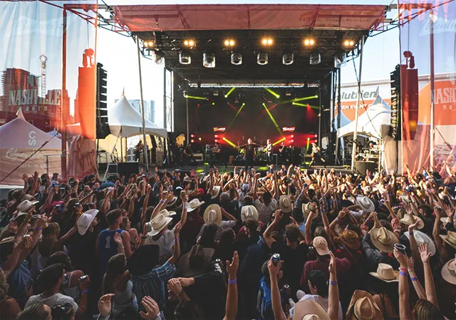 concertgoers enjoying live music in the Nashville North tent