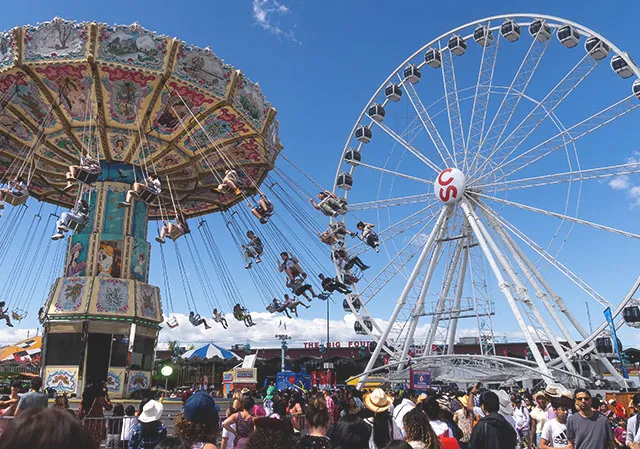 Lifted swings and Ferris wheel at the Stampede Midway