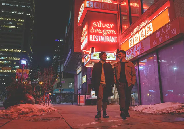 couple walking outside of Silver Dragon Restaurant in Calgary's Chinatown