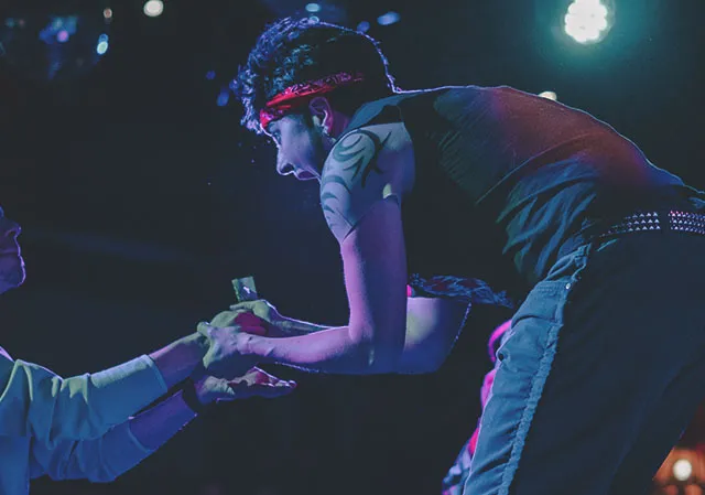 A fan tipping performer, Brad Diesel, at Dickens Pub (Photo Credit: Hayden McHugh)