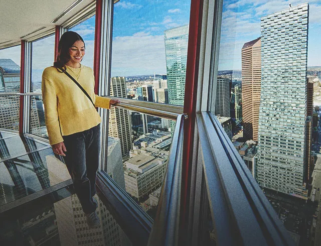 Woman walking on the Calgary Tower's glass floor