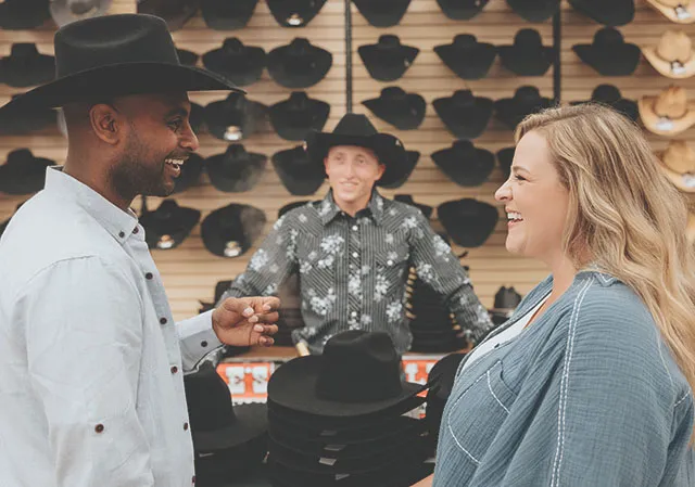 couple shopping for cowboy hats at Lammles