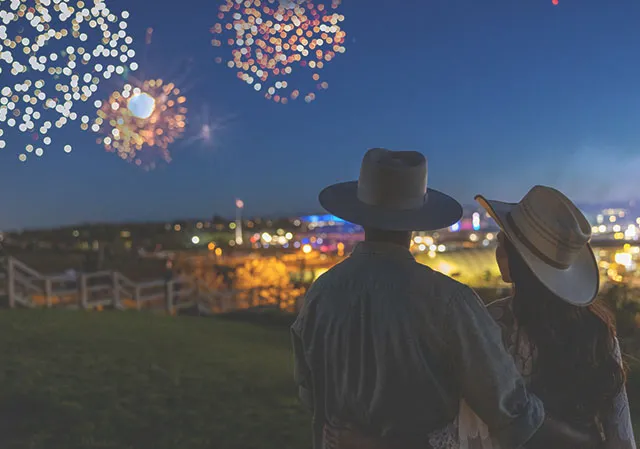 couple watching the stampede frieworks show from afar