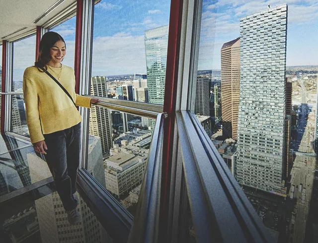 Woman looking out from the Calgary Tower 