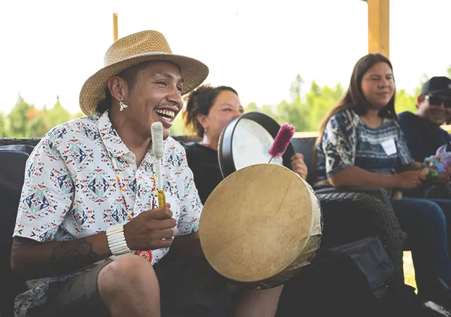 Indigenous drummer plays to a crowd a Dodging Horse Ranch