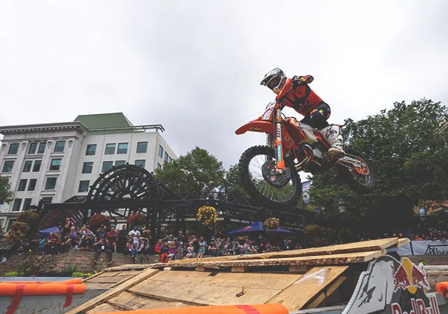motocross biker jumping over an obstacle on the Red Bull Outliers course
