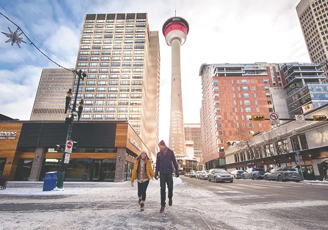 Couple walking in front of the Calgary Tower