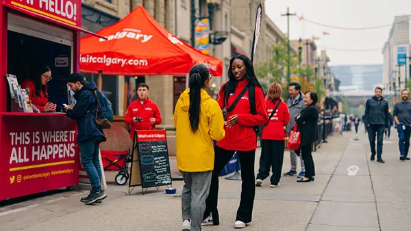 Visitor Hub experts helping a traveller in Calgary