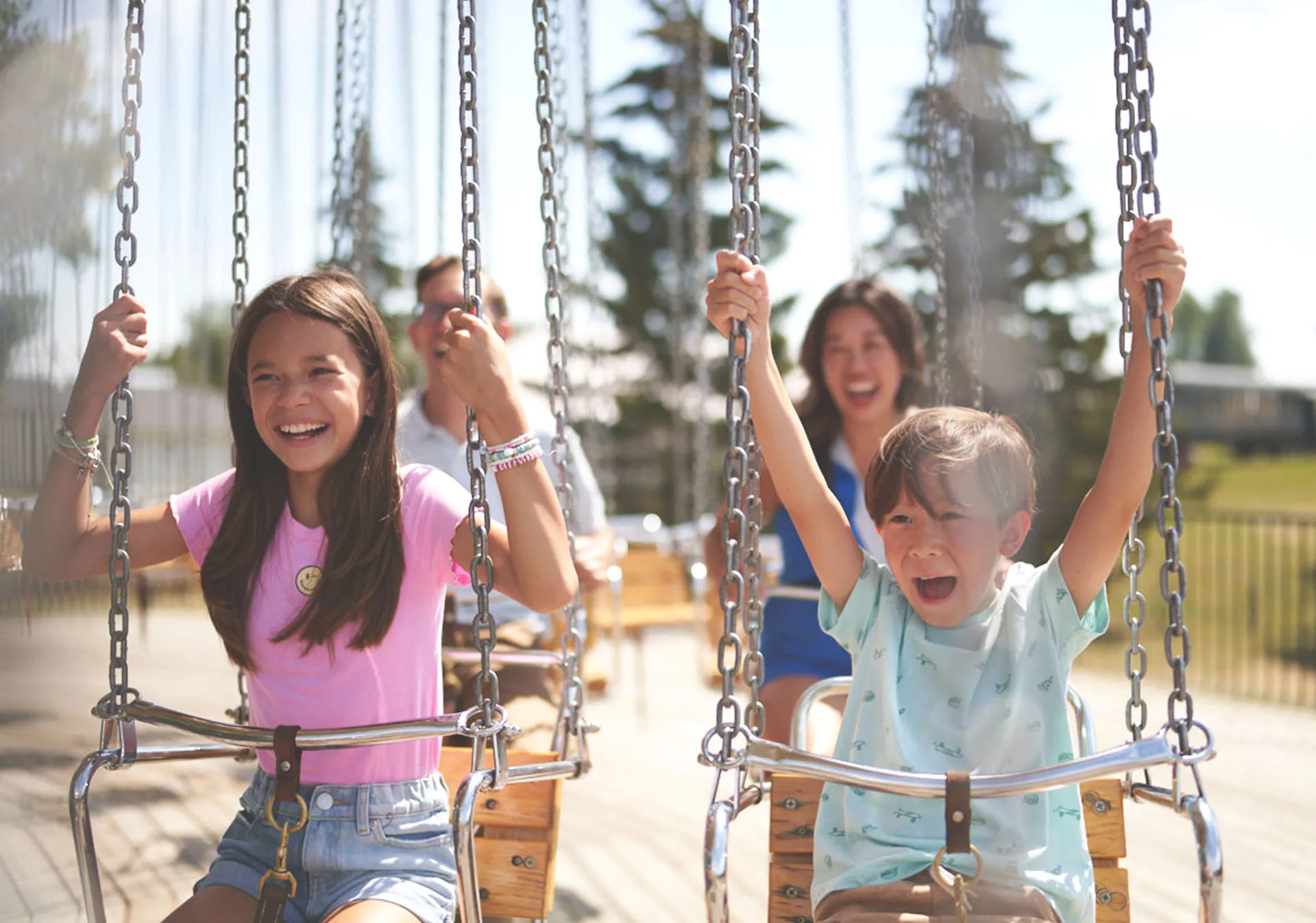 two children on the swing ride at Heritage Park's midway