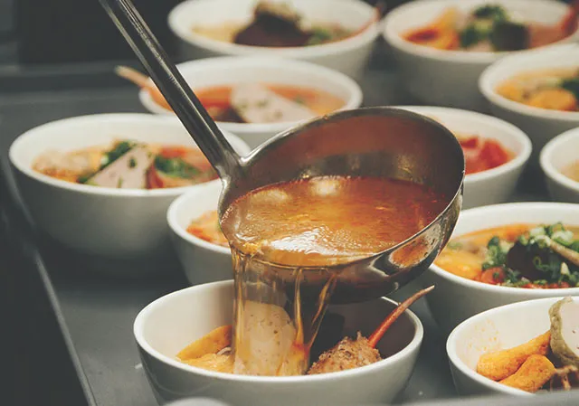 ladling soup into bowls at Mot To