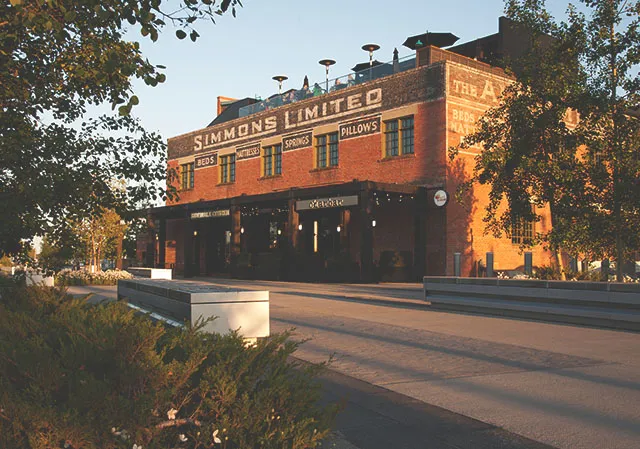 photograph of the outside of the Simmons building along the RiverWalk in Calgary