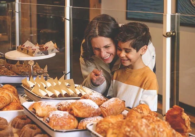 family picking out assorted baked goods at Sidewalk Citizen