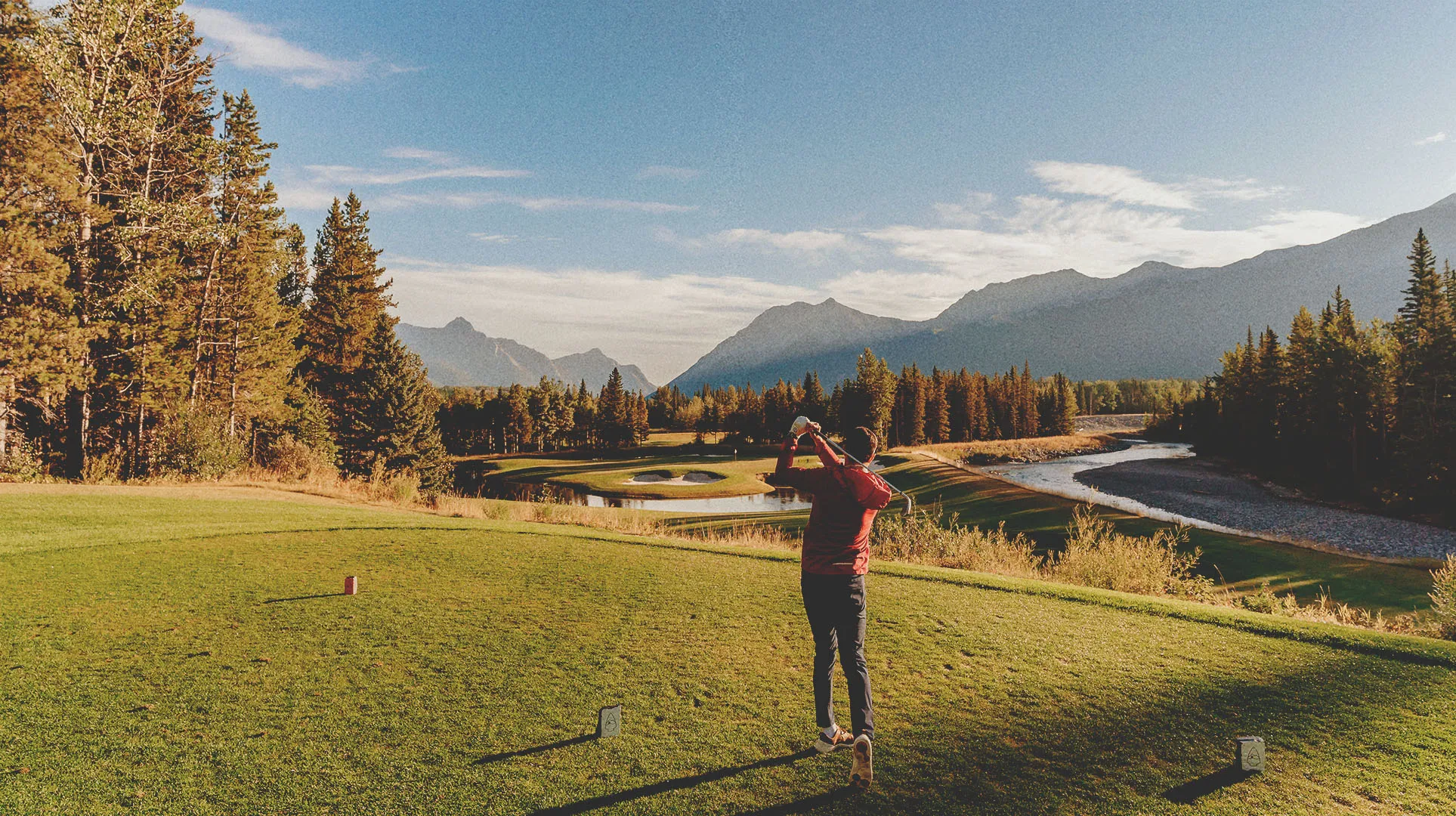 Golfer swinging at Kananaskis Golf Course