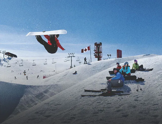 snowboarder jumping at WinSport ski hill in Calgary