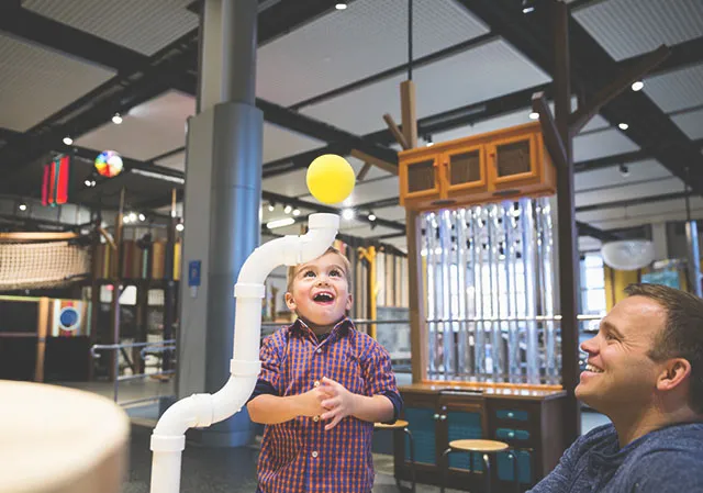 young child admiring a science experiment at TELUS Spark