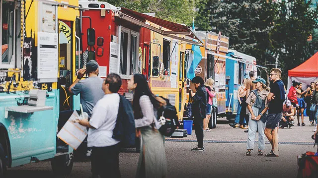 crowds ordering food from food trucks at a culinary festival