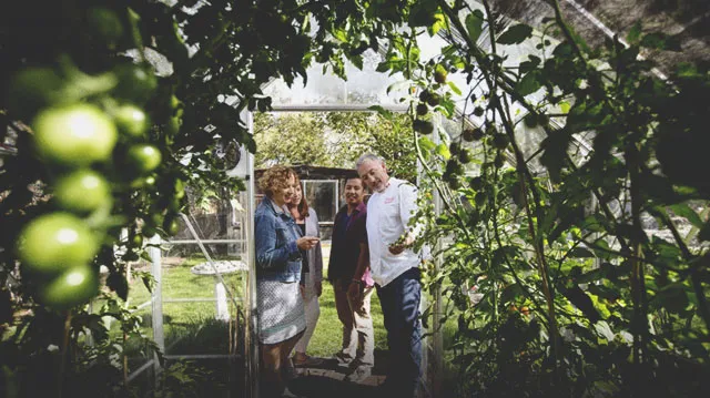 Chef takes a group for a garden tour at Rouge Restaurant