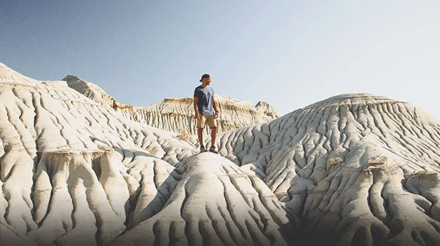 Man exploring the Badlands of Dinosaur Provincial Park