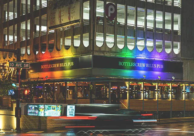 exterior or Bottlescrew Bill's at night, as it is lit up with rainbow colours to celebrate Pride