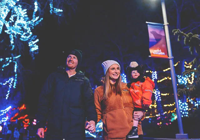 family walking through lights displays at ZOOLIGHTS