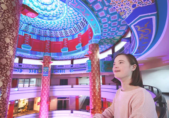 young girl admires the 70 foot decorative ceiling at the Calgary Chinese Cultural Centre