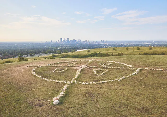 An Indigenous Medicine Wheel at Nose Hill Park marks sacred ground once used for ceremony. The skyline can be seen far in the distance