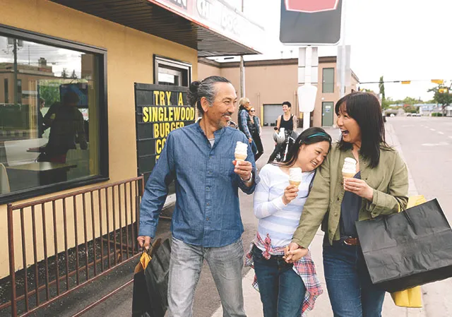 family walking outside Inglewood Drive-In with ice cream