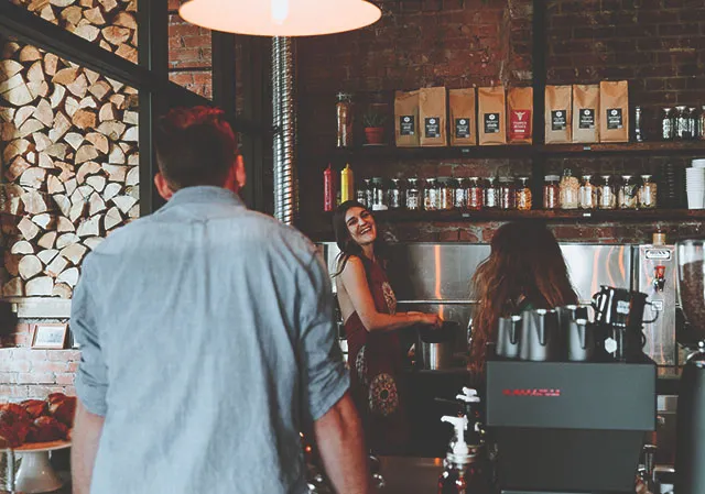 a man orders coffee from a barista at Calgary Heritage Roasting Company