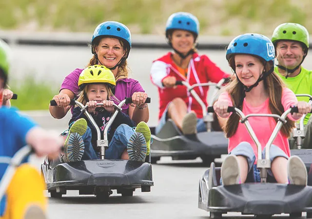 people of all ages riding in karts at Downhill Karting