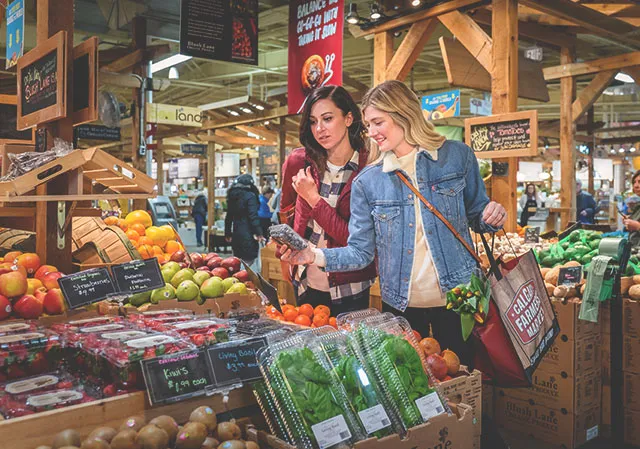 two ladies picking out produce at Calgary Farmers Market South