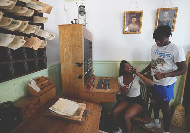 young couple interacting with antique museum display items at Heritage Park Historical Village