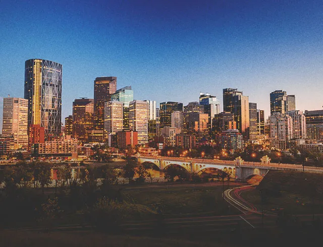 downtown Calgary skyline at dusk seen from Rotary Park facing south down Centre street