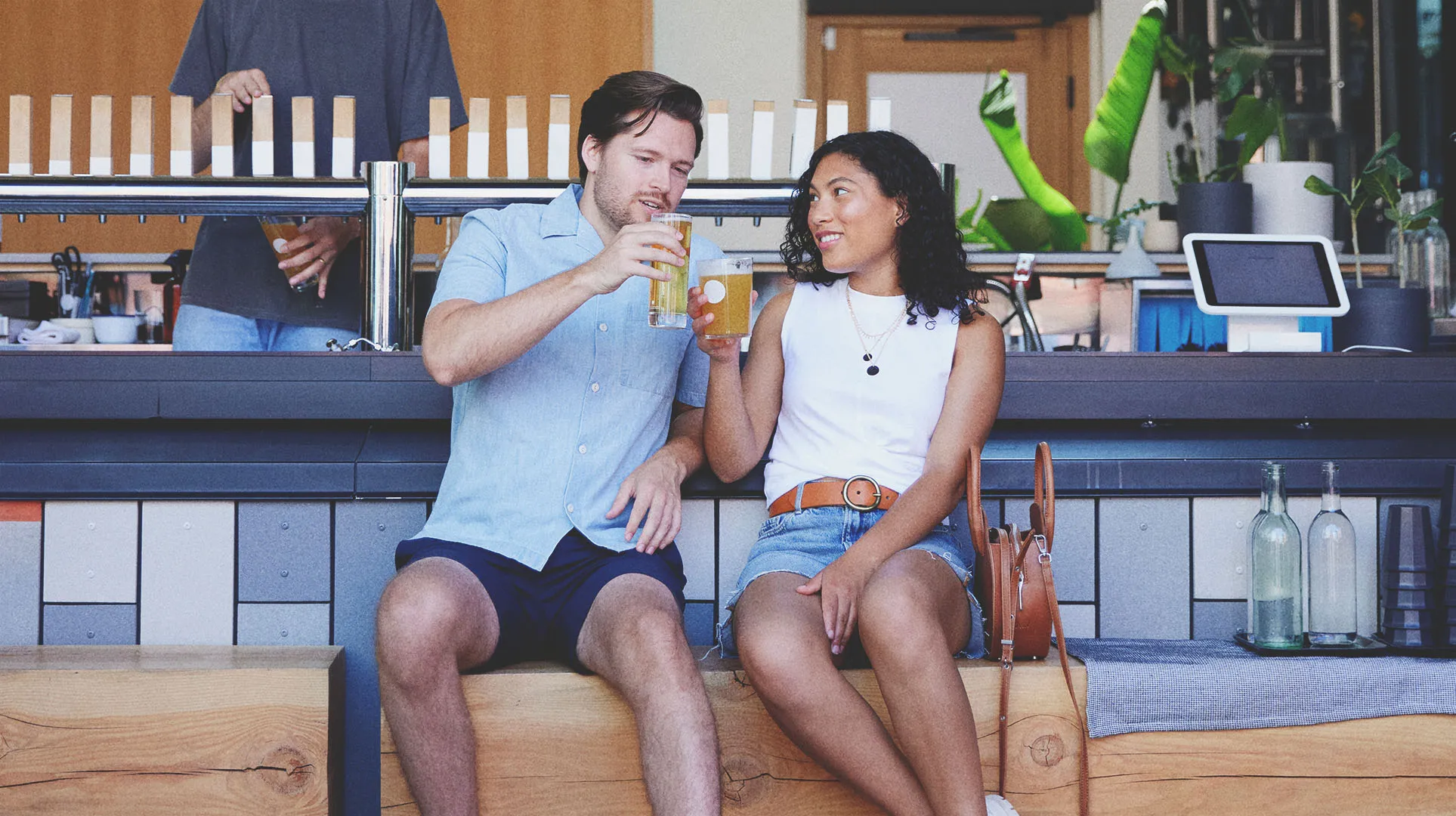 Couple enjoying pints of beer outside at 33 Acres Brewing Co in Calgary's beltline