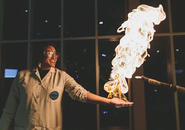 TELUS Spark Science Centre worker demonstrating fire