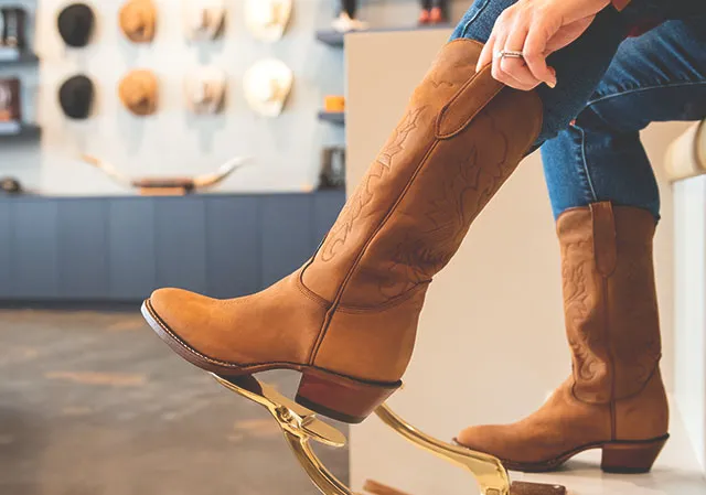 customer trying on boots at Alberta Boot Company Outfitters