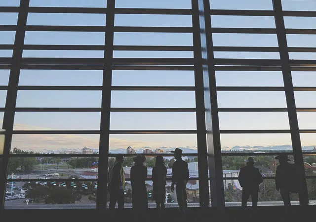 Guests look out expansive windows in the Champions Ballroom