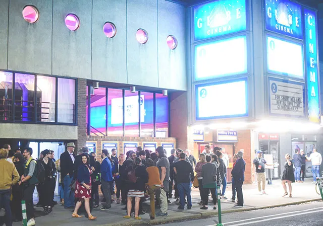 Fans wait outside The Globe Cinema for the next festival screening