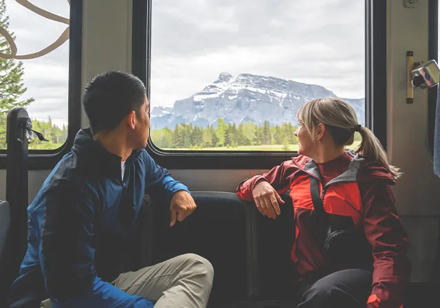 Couple looking out from a Roam Transit bus in Banff