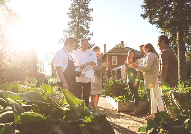 Guests enjoy a garden tour at Rouge