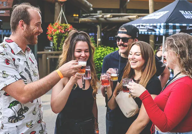 a group of people cheering Wild After Hours at ZooBrew