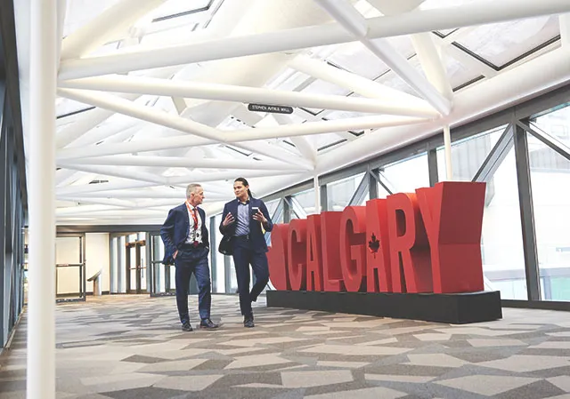 two men walking in the Calgary TELUS Convention Centre