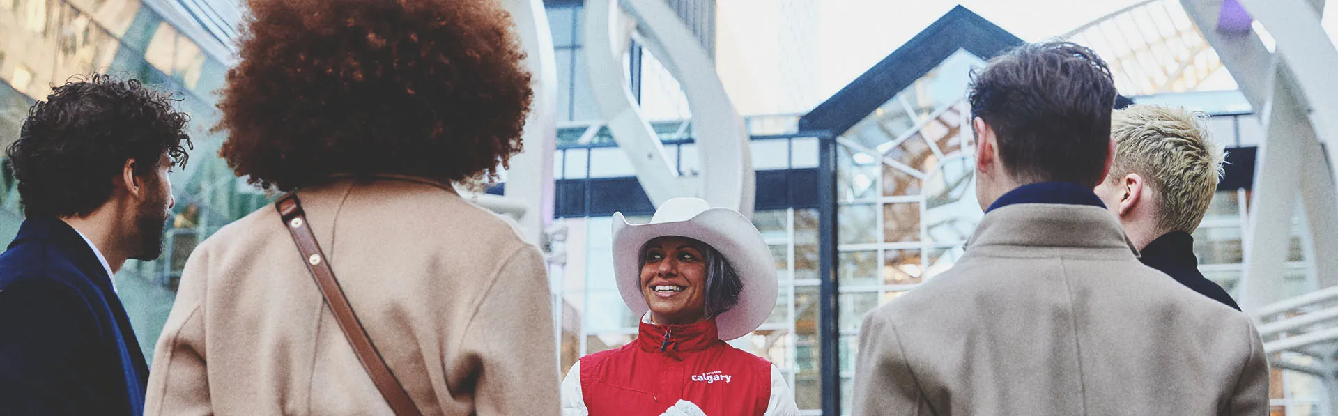 a lady smiling and talking to a group of delegates
