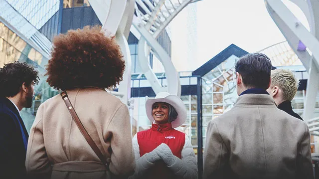 a lady smiling and talking to a group of delegates