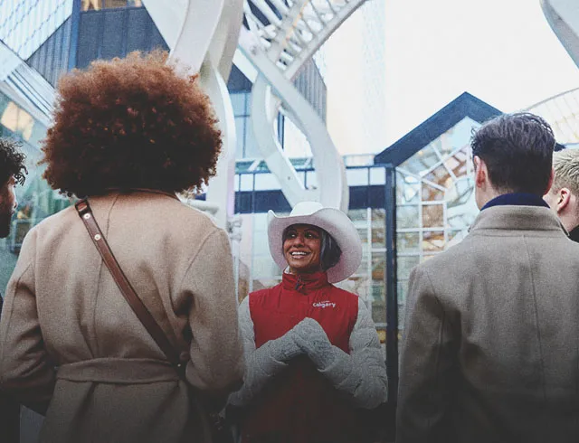 a lady smiling and talking to a group of delegates
