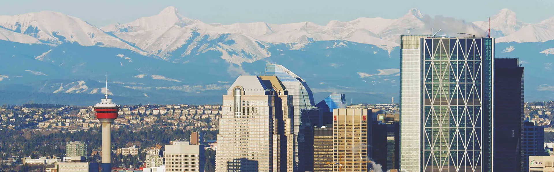 Calgary skyline during Summer with Rocky Mountains in the background