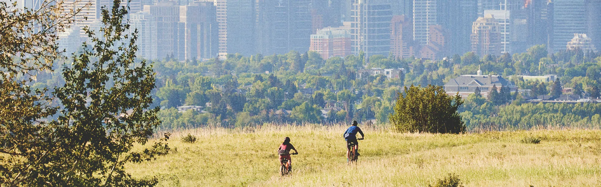 2 people biking through Nose Hill Park