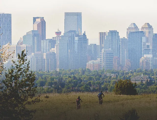 2 people biking through Nose Hill Park