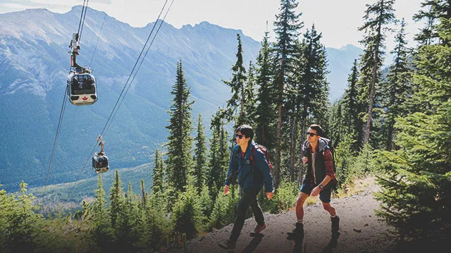 people hiking in Banff with the gondola in the background