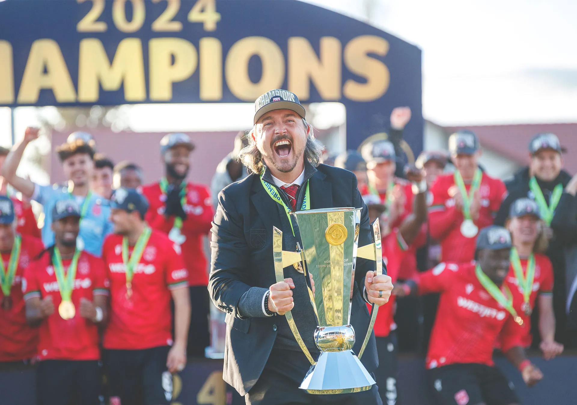 Head Coach of Cavalry FC, Tommy Wheeldon Jr., hoists the North Star Cup after winning the 2024 Championship