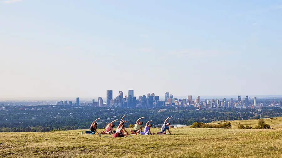 a group of people practicing yoga at Nose Hill park